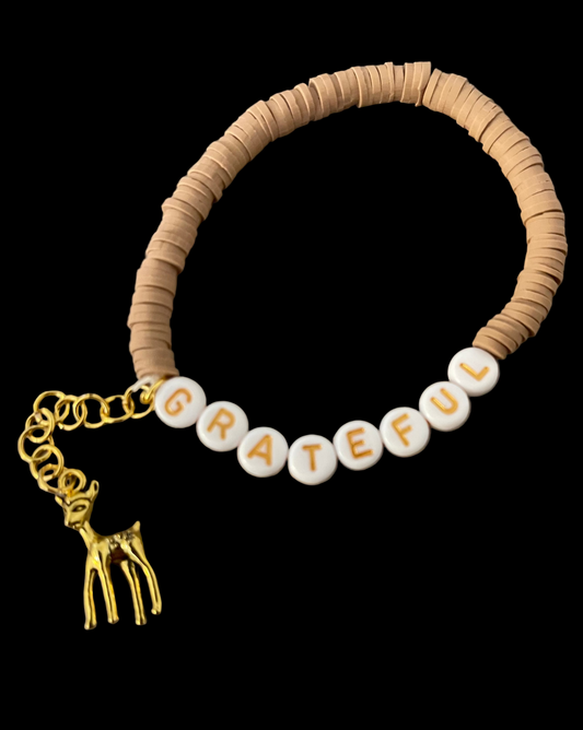 Fall/autumn themed bracelet with autumn colors and a like gold deer charm dangling